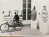 Spazio espositivo con manichini e un ciclista d'epoca